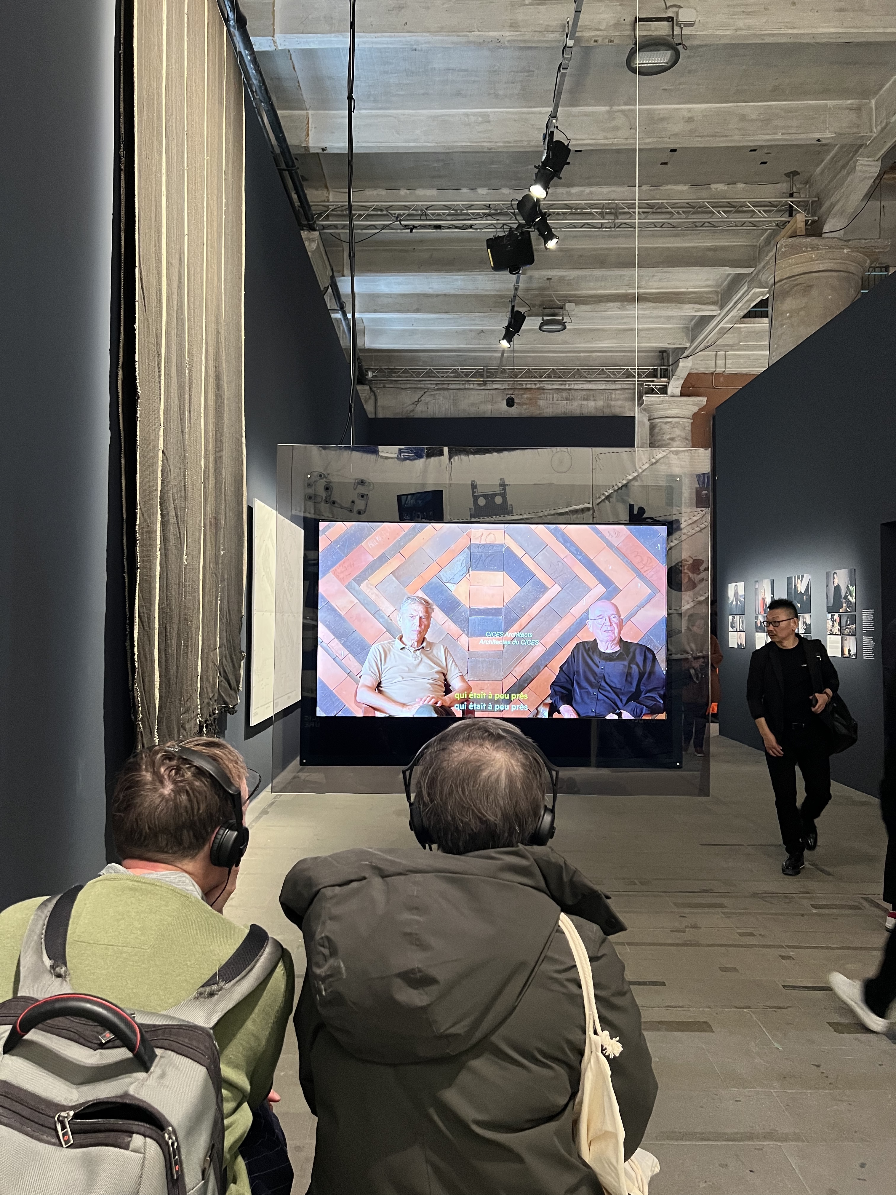 viewers watch a film at the venice biennale