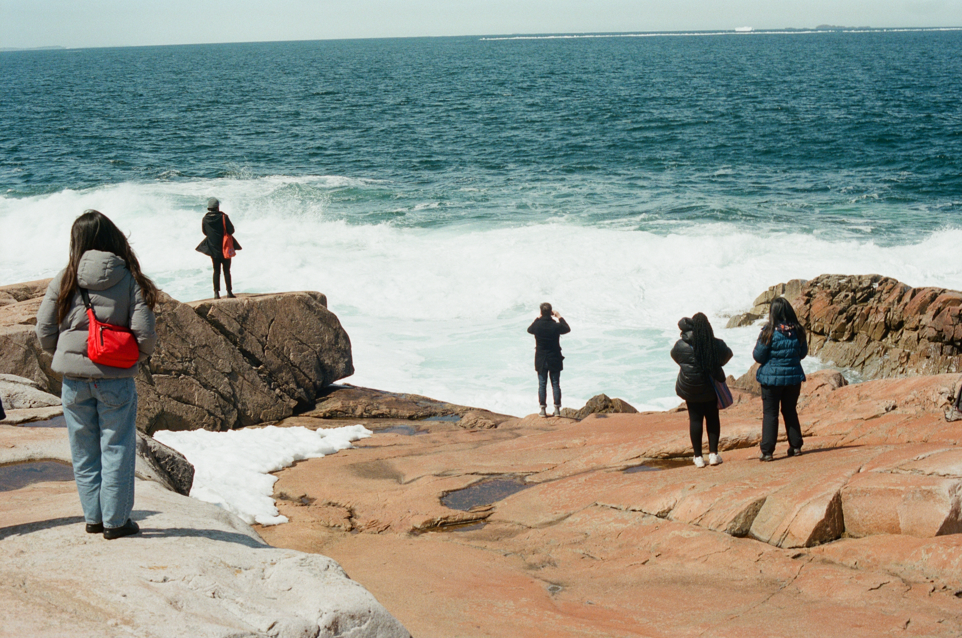 daniels students stand near the atlantic ocean