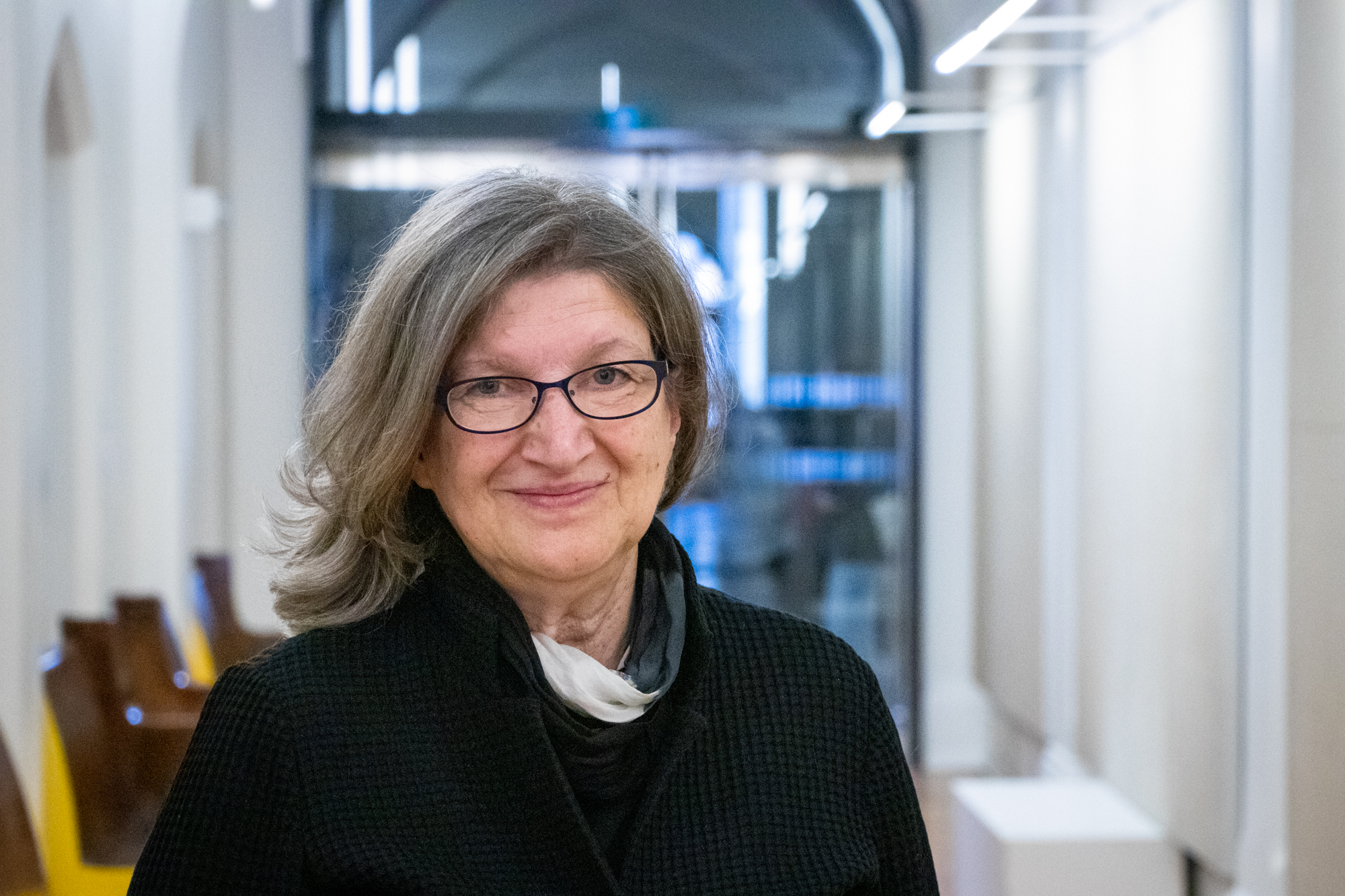 portrait of Barbara Fischer in a hallway