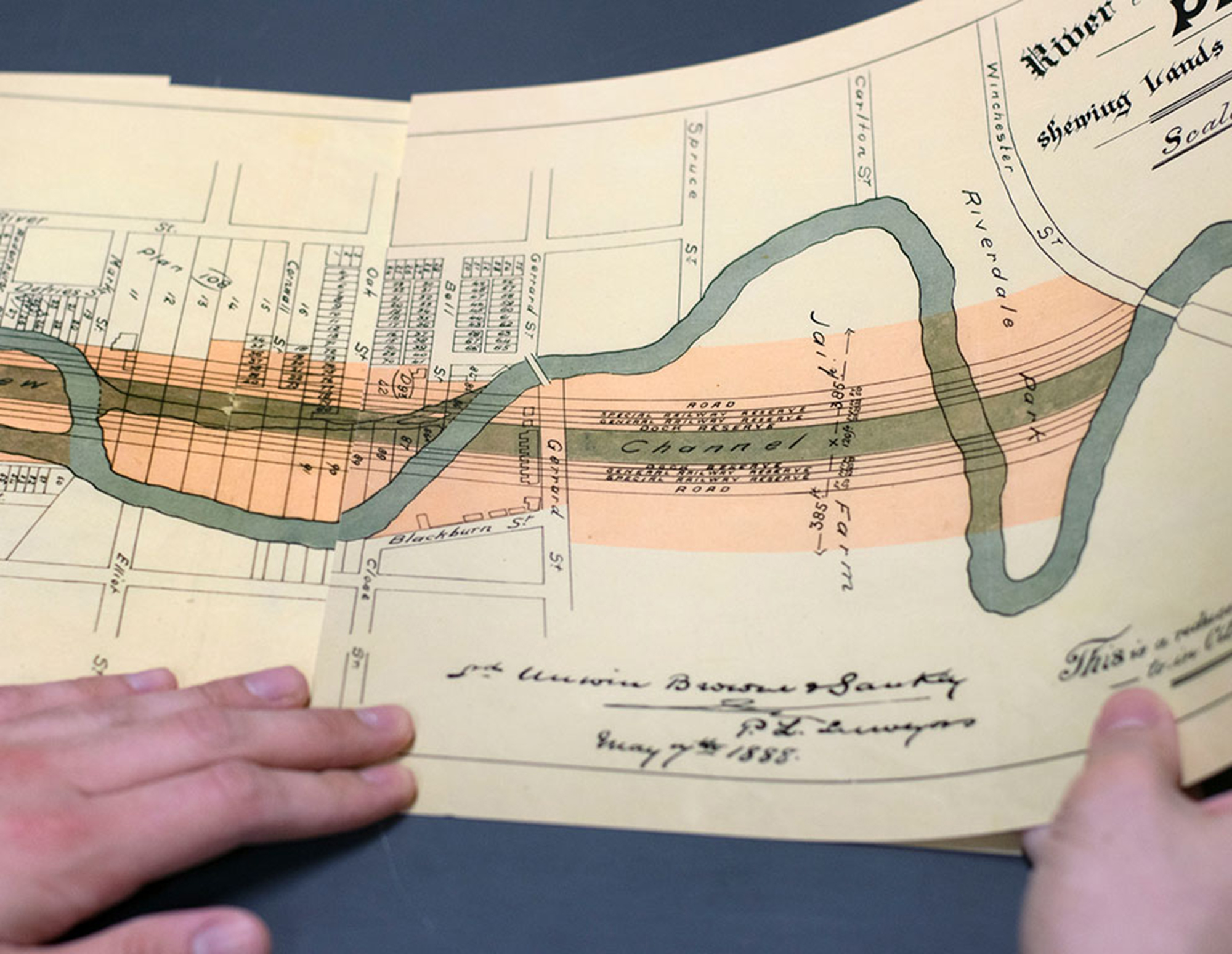Artist holding image of River Don Straightening Plan, 1888, by Chris Mendoza
