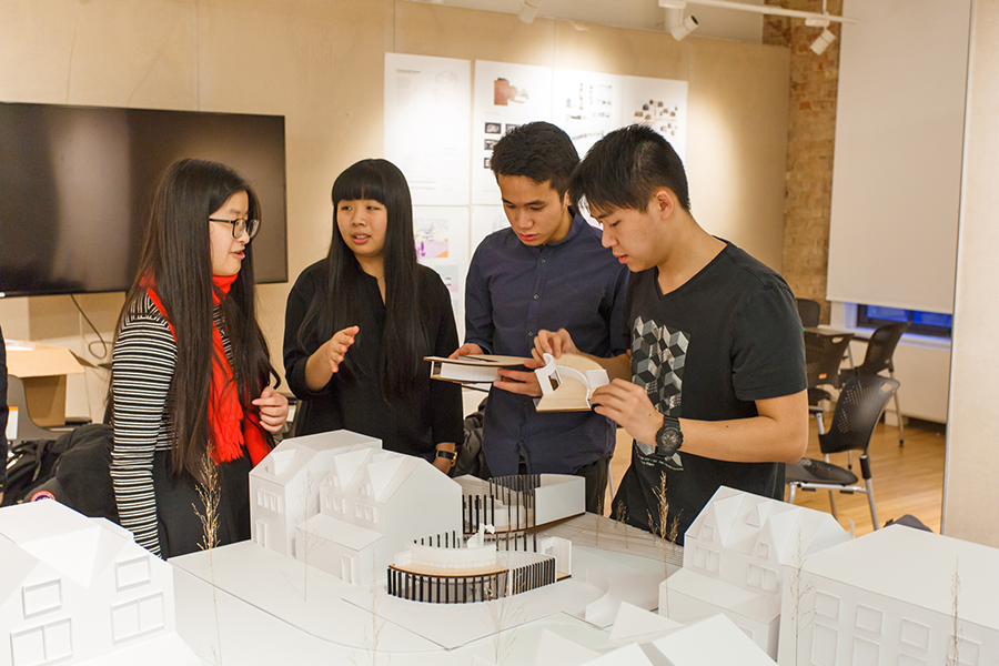 Group of students looking at model